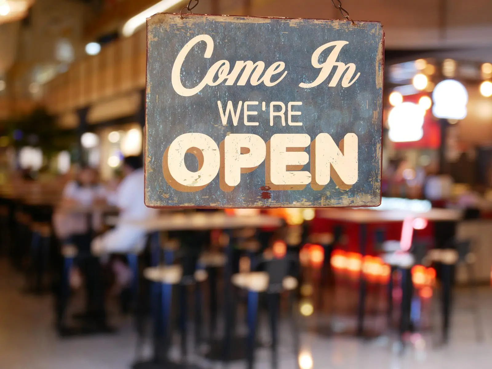 Restaurant open sign hanging on front door welcoming customers